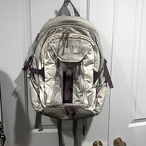 Grey and white with purple accented The North Face backpack.
